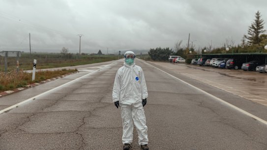 A volunteer from the Spanish Red Cross wearing personal protective equipment transfers COVID-19 patients to the La Albubilla nursing home where patients who have tested positive at Covid-19 remain on April 1, 2020 in Huesca, Spain.