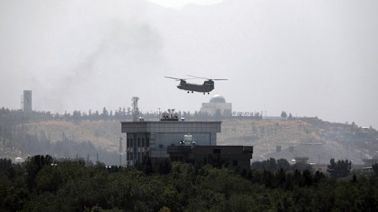 A U.S. Chinook helicopter flies over the US Embassy in Kabul, Afghanistan, Sunday, August 15, 2021.