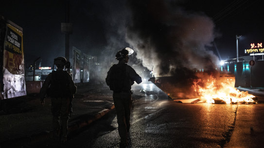 Israeli police patrol during clashes between Arabs, police and Jews, in the mixed town of Lod, central Israel.