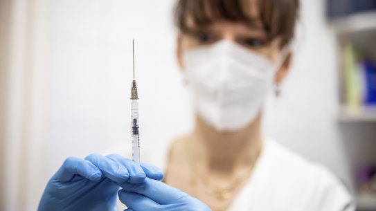 A health worker prepares a dose of Pfizer-BioNTech vaccine.