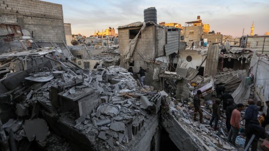 People inspect the damage to their homes following Israeli airstrikes on Rafah, Gaza.