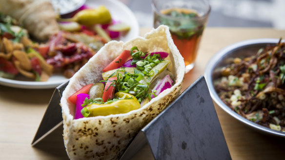 The pickle-heavy falafel pita (centre) and koshari (right) at Cairo Takeaway.