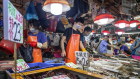 Vendors wearing masks sell seafood at an open-air wet market in China; a similar market in Wuhan was identified as a possible source of the first outbreak of coronavirus in December 2019. 