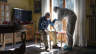 A member of the Italian Red Cross checks a COVID-19 patient during a round of home visits in Bergamo, Italy.
