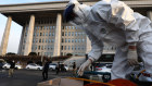 Cleaning up politics. A worker in protective gear sprays anti-septic solution against COVID-19 at the National Assembly in Seoul. The National Assembly called off its plenary session and temporarily closed its buildings after it was learned that a coronavirus patient attended a parliamentary forum last week.