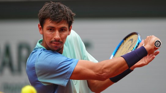 Alexei Popyrin returns the ball to Tommy Paul during their fourth round match.