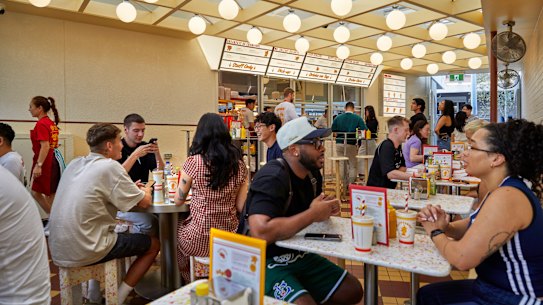 The covered courtyard is reminiscent of a 1950s Californian drive-in or a 1980s McDonald's.