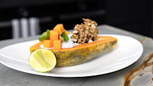 A papaya boat with coconut chia pudding, crunchy honey nut and vanilla yoghurt.
