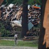 Officials comb through the banks of the Guadalupe River after a flash flood swept through the area Saturday, July 5, 2025, in Hunt, Texas. (AP Photo/Julio Cortez)