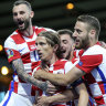 Teammates mob Luka Modric after the Croatia talisman scored his side’s second goal against Scotland.