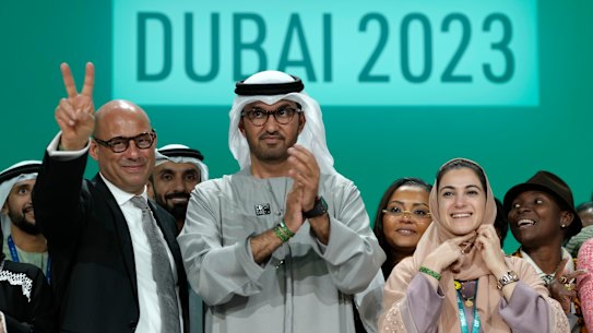 United Nations Climate Chief Simon Stiell, from left, COP28 President Sultan al-Jaber and Hana Al-Hashimi, chief COP28 negotiator for the United Arab Emirates, pose at the end of the COP28 U.N. Climate Summit, Wednesday, Dec. 13, 2023, in Dubai, United Arab Emirates. (AP Photo/Peter Dejong)