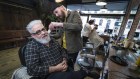 Razor Smiths owner Tom Donato, seated, said small business was “willing to negotiate” on flexibility.