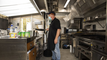 Local chef Sam cooks up breakfast for the police officers at Cann River on Wednesday.