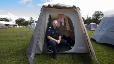 Victoria Police Acting Senior Sergeant Colin Shepherd who was deployed from the Bass Coast sits in his tent at Cann River on Wednesday.
