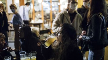 Eugenie Finidori drinks her last beer on a bar terrace in Paris.