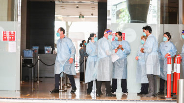 Hotel quarantine workers wearing full protective equipment at the Grand Hyatt Melbourne Hotel.