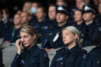 Police officers mourn their fallen colleagues on Thursday. 