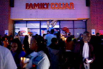 People mourn outside the Family Dollar store in Flint, Michigan.