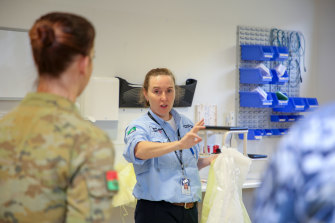 Infection prevention and control adviser Jennifer White briefs defence force health professionals in the North West Regional Hospital in Burnie, Tasmania, after the hospital's formal handover from contracted cleaning personnel.