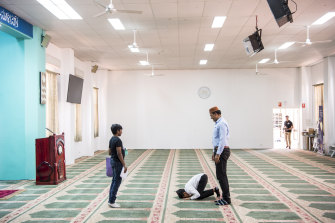 Ahmadiyya Muslim children prepare for  prayer.