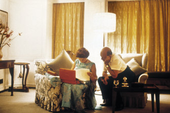 Queen Elizabeth and her private secretary Sir Martin Charteris reviewing papers late at night on the royal yacht Britannia in 1971.