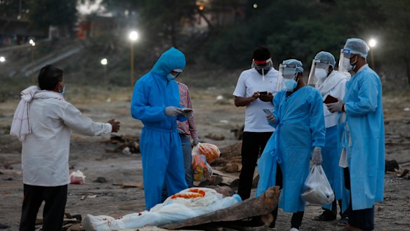Family members pay last respect to their relative, a 62-year-old man who has lost his life to a coronavirus infection before cremation at River Ganges in India.