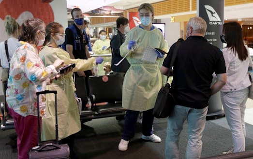 Passengers arriving from Melbourne are screened at Sydney airport.