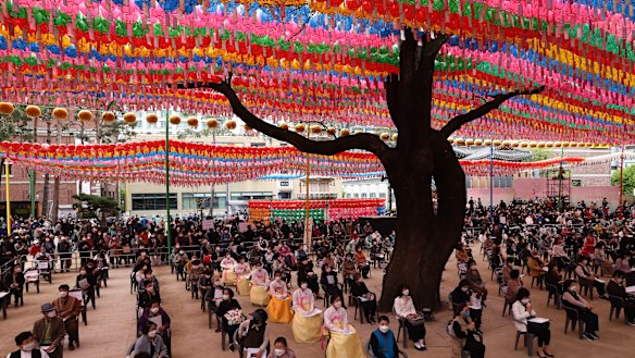 Koreans wear masks as they gather during a birthday of Buddha service to pray for the defeat of the coronavirus pandemic at Jogyesa Temple in Seoul, South Korea. 