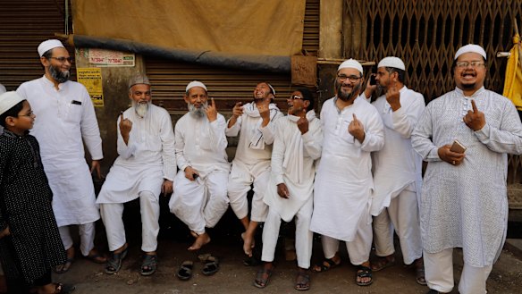 Indian Muslims display indelible ink marks on their fingers after casting their votes in Varanasi, India. 