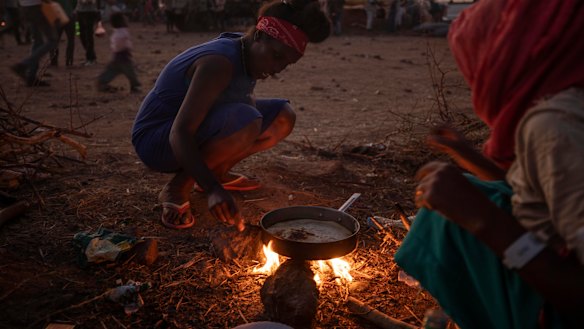 Tigray women who fled the conflict in Ethiopia's north, cook at a refugee camp in eastern Sudan on Friday.