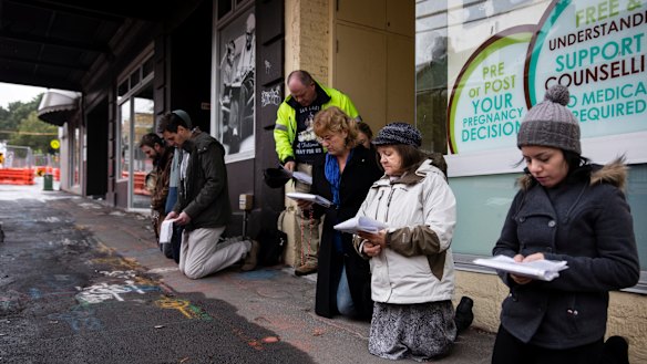 People pray outside an abortion clinic in Surry Hills.