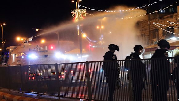 Israeli police use a water cannon to disperse Palestinian protesters from the area near the Damascus Gate in the Old City of Jerusalem.