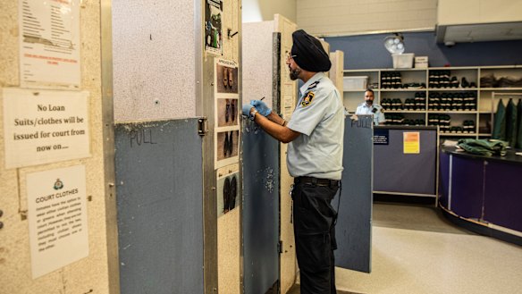 A prison officer speaks to an inmate at Silverwater during the screening process.