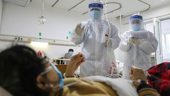 Medical workers check on the conditions of patients in Jinyintan Hospital, designated for critical COVID-19 patients, in Wuhan.