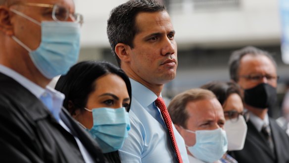 Flanked by party members, Venezuelan opposition leader Juan Guaido, centre, stands during a press conference, a day after parliamentary elections. Guaido is recognised by dozens of countries as the president of Venezuela.