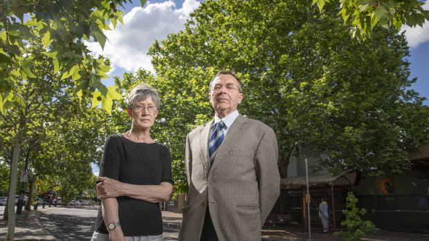 Griffith Narrabundah Community Association member Anne Forrest and president Leo Dobes stand in front of a large protected tree in Griffith that developers are trying to have deregistered. 