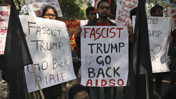 Communist Party of India activists hold banners during a protest against the visit of US President Donald Trump in Delhi.