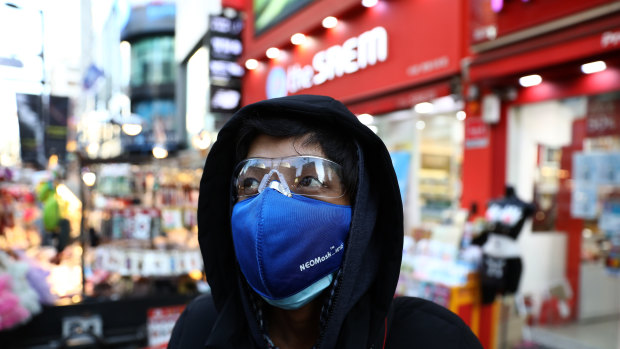 A man wears a mask to prevent the coronavirus in the Myungdong shopping district in Seoul. 