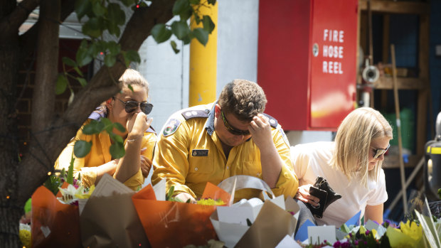 RFS colleagues mourn the deaths at the makeshift memorial at Horsley Park.