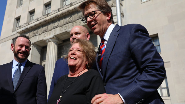 Plaintiff Gail Ingham  stands outside the civil courthouse with attorneys Lee Cirsch, from left, Eric Holland and Mark Lanier following the verdict.