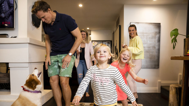 Crowded house: Trent Salkavich and Emily Smith with their children Ella (3, in stripes), Annabel (6, in pink), au pair Charli Slarks and dog Sundae at home in Greenwich.