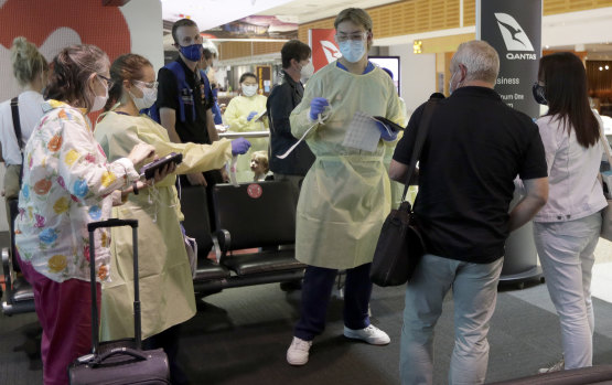 Passengers arriving from Melbourne are screened at Sydney airport.