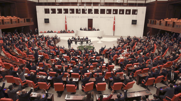 Members of Turkey's parliament vote to send Turkish troops to Libya to help the UN-supported government in Tripoli .