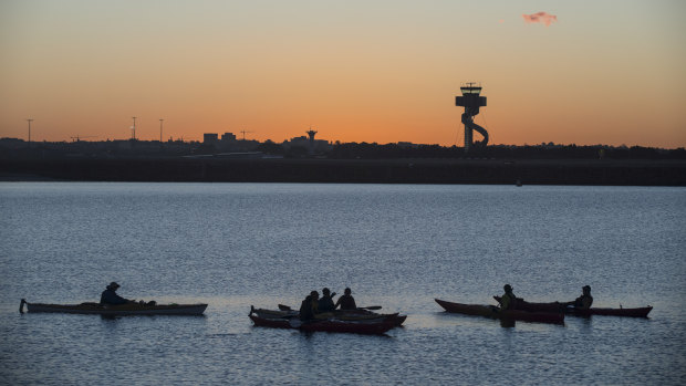 Kayakers enjoy a break at the mouth of the Cooks River at Botany Bay.