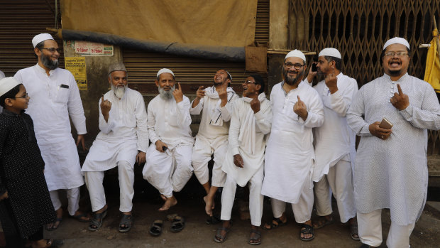 Indian Muslims display indelible ink marks on their fingers after casting their votes in Varanasi, India. 