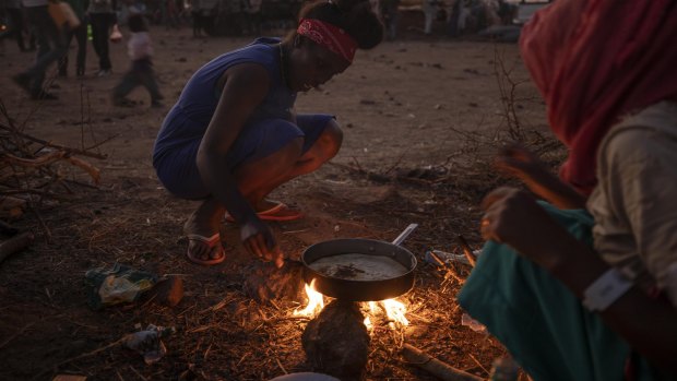 Tigray women who fled the conflict in Ethiopia's north, cook at a refugee camp in eastern Sudan on Friday.