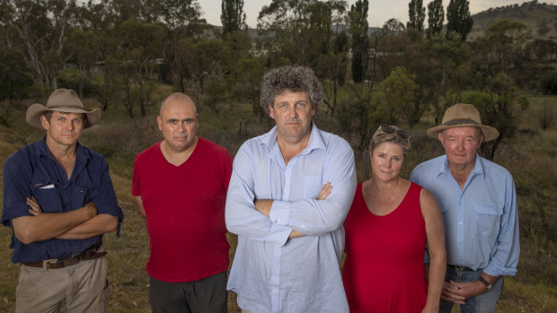 Tharwa residents, from left, Myles Gostelow, Karim Haddad, Kevin Jeffery, Janet Flint and Michael Lonergan stand near the site of a proposed firefighting water supply on the Murrumbidgee River which they say won't serve the village's needs.
