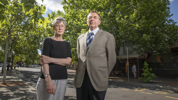 Griffith Narrabundah Community Association member Anne Forrest and president Leo Dobes stand in front of a large protected tree in Griffith that developers are trying to have deregistered. 