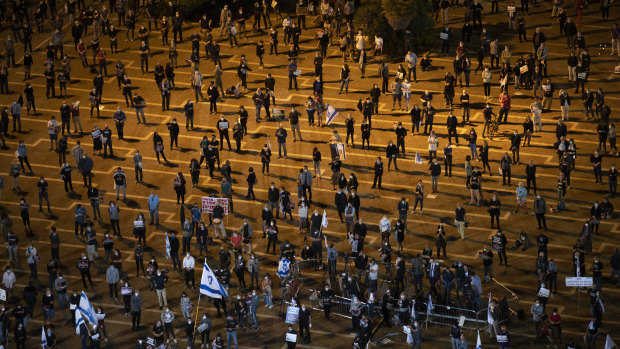 People keep social distancing during a protest against Prime Minister Benjamin Netanyahu in Tel Aviv.