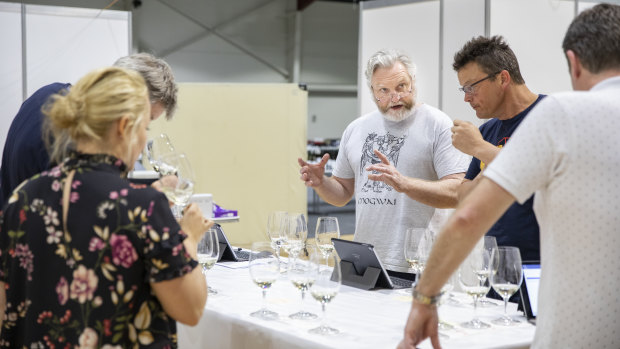 Chairman of judges David Bicknell confers with judges at the National Wine Show.